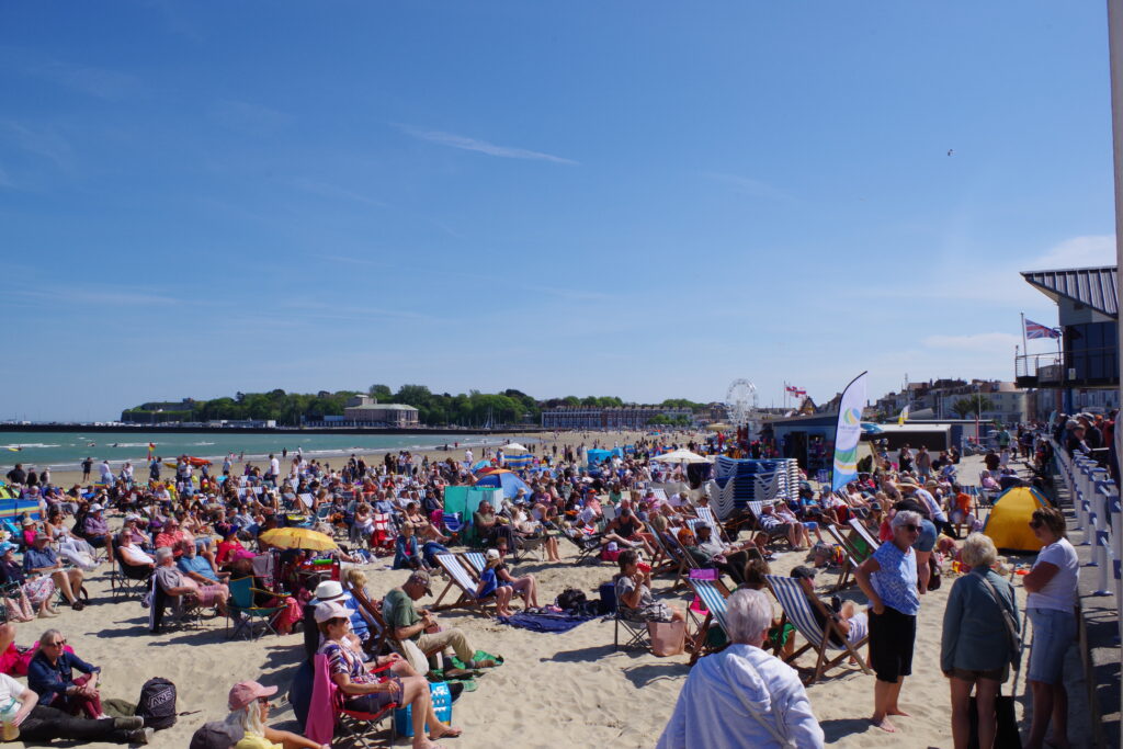 Crowd on the beach watching the concert.